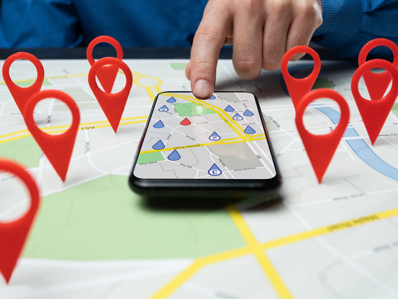 Smartphone over a street map of Ashburn marked with local business location pins