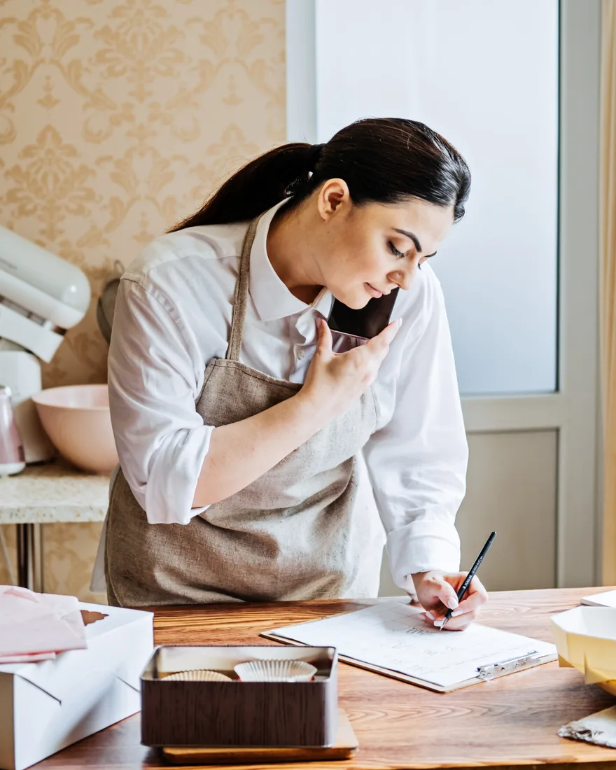 Local business owner taking a customer call generated by paid search