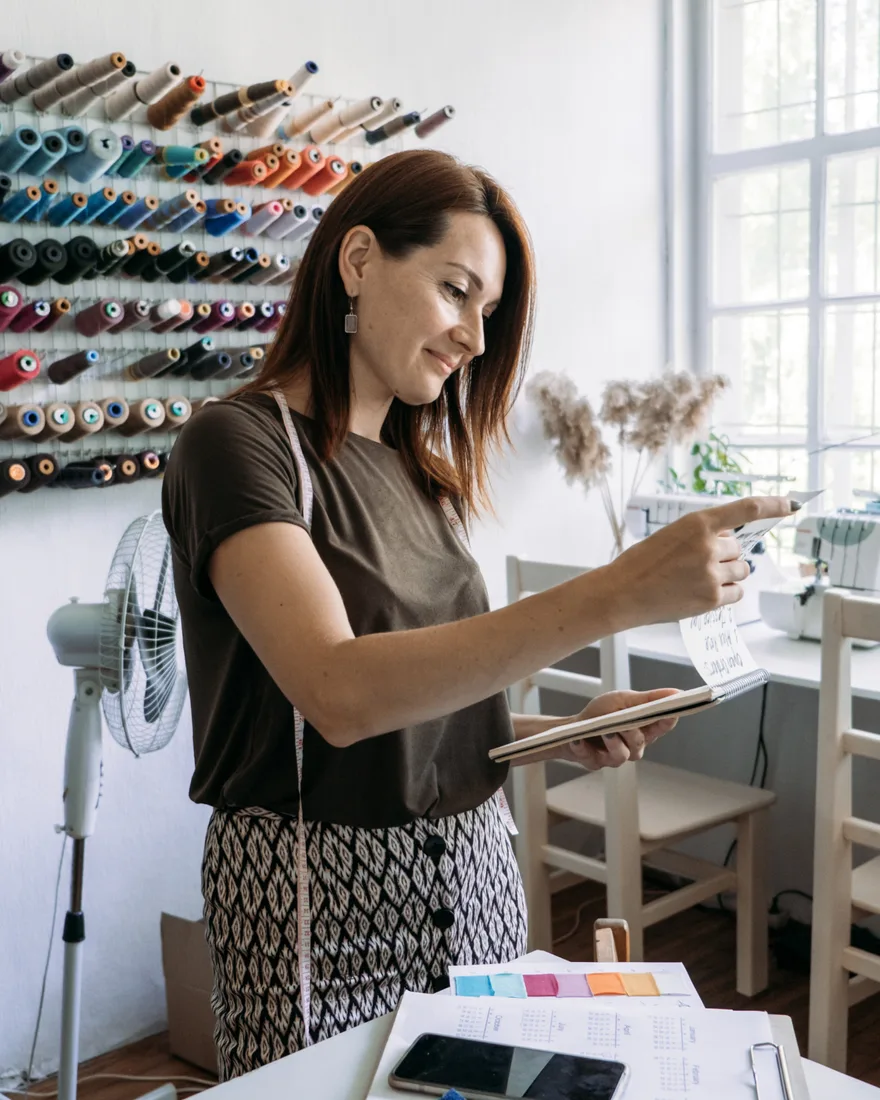 Business owner managing her website and orders on a tablet