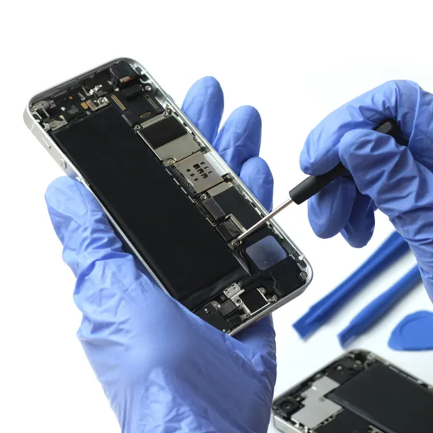 Technician repairing a smartphone