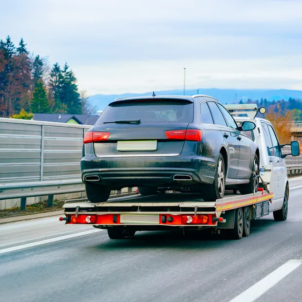 Tow truck hauling a car on the highway